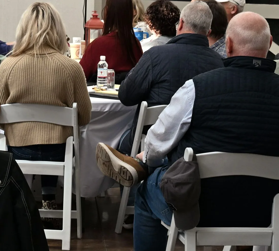 A corporate team seated at round tables during a meeting in the Grand White Barn, a private event venue near Knoxville.