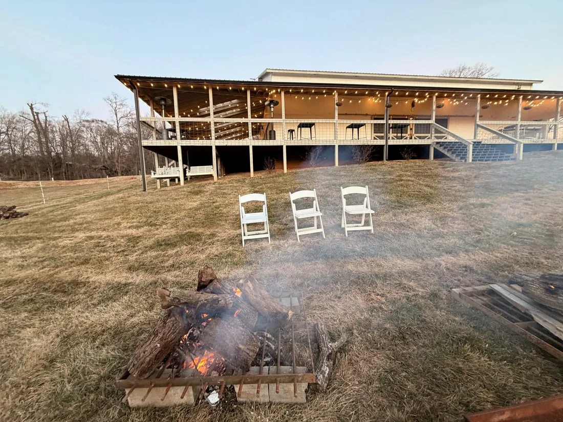 Wood fires burning beside the Milkbarn porch at dusk after a corporate retreat in New Market, Tennessee.