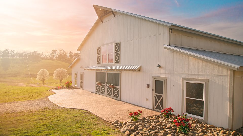 The Grand White Barn at golden hour, the reception barn for a Tennessee farm wedding in the Smoky foothills