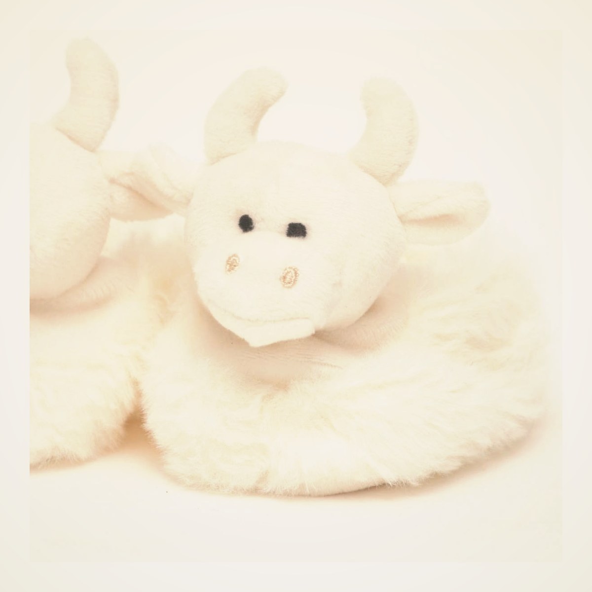 Highland Cow Plush Baby Slippers from the STUFFIES shelf at the Cedar Pond Farms gift shop — our fluffy Highland cow farm just outside the Smoky Mountains.