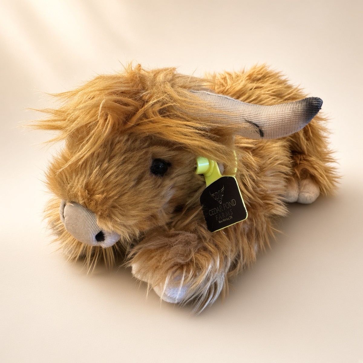Living Nature Living Nature Lying Highland Cow Stuffed Toy from the STUFFIES shelf at the Cedar Pond Farms gift shop — our fluffy Highland cow farm just outside the Smoky Mountains.