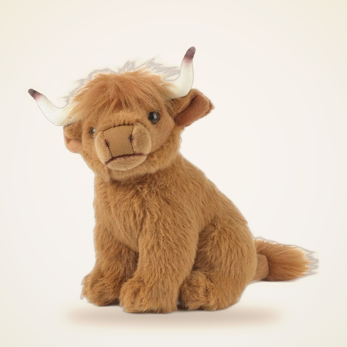Curious Scottish Highland Cow Small Plush Stuffed Animal Toy from the STUFFIES shelf at the Cedar Pond Farms gift shop — our fluffy Highland cow farm just outside the Smoky Mountains.