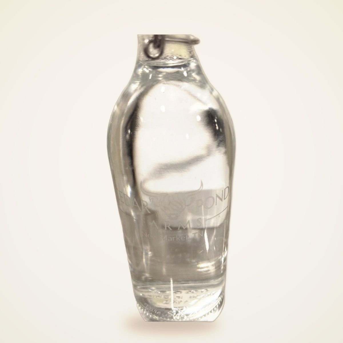 Clear glass bottle with wire-latch cap, embossed with the Cedar Pond Farms logo and 'New Market, TN'.