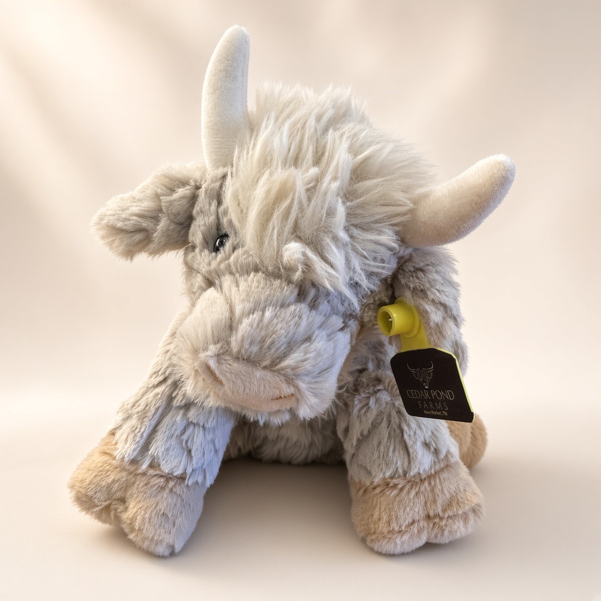 Putty Colored Highland Cow Stuffed Animal from the STUFFIES shelf at the Cedar Pond Farms gift shop — our fluffy Highland cow farm just outside the Smoky Mountains.