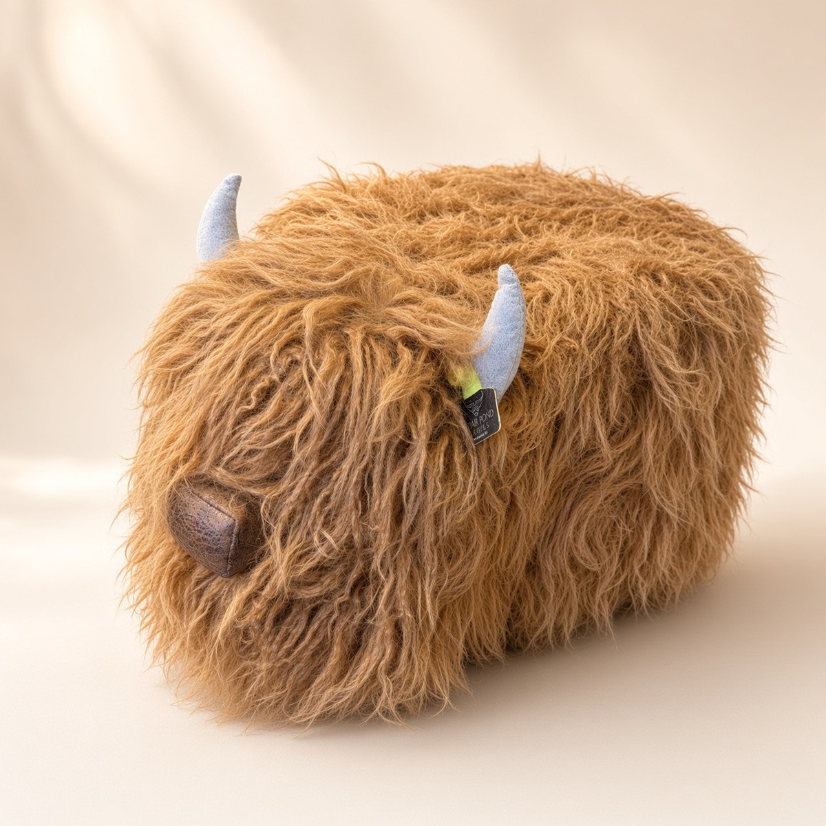 Highland Cow Footstool from the MISC shelf at the Cedar Pond Farms gift shop — our fluffy Highland cow farm just outside the Smoky Mountains.