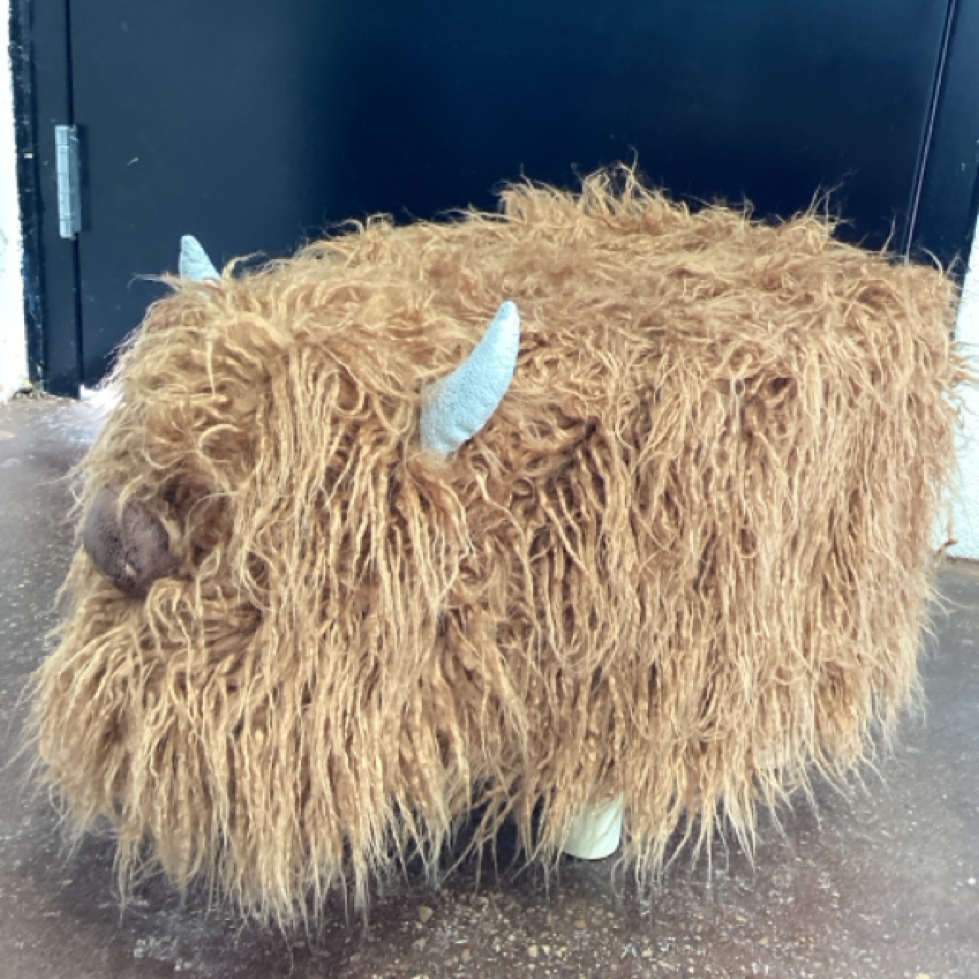 Highland Cow Footstool at the Cedar Pond Farms gift shop — our fluffy Highland cow farm just outside the Smoky Mountains.