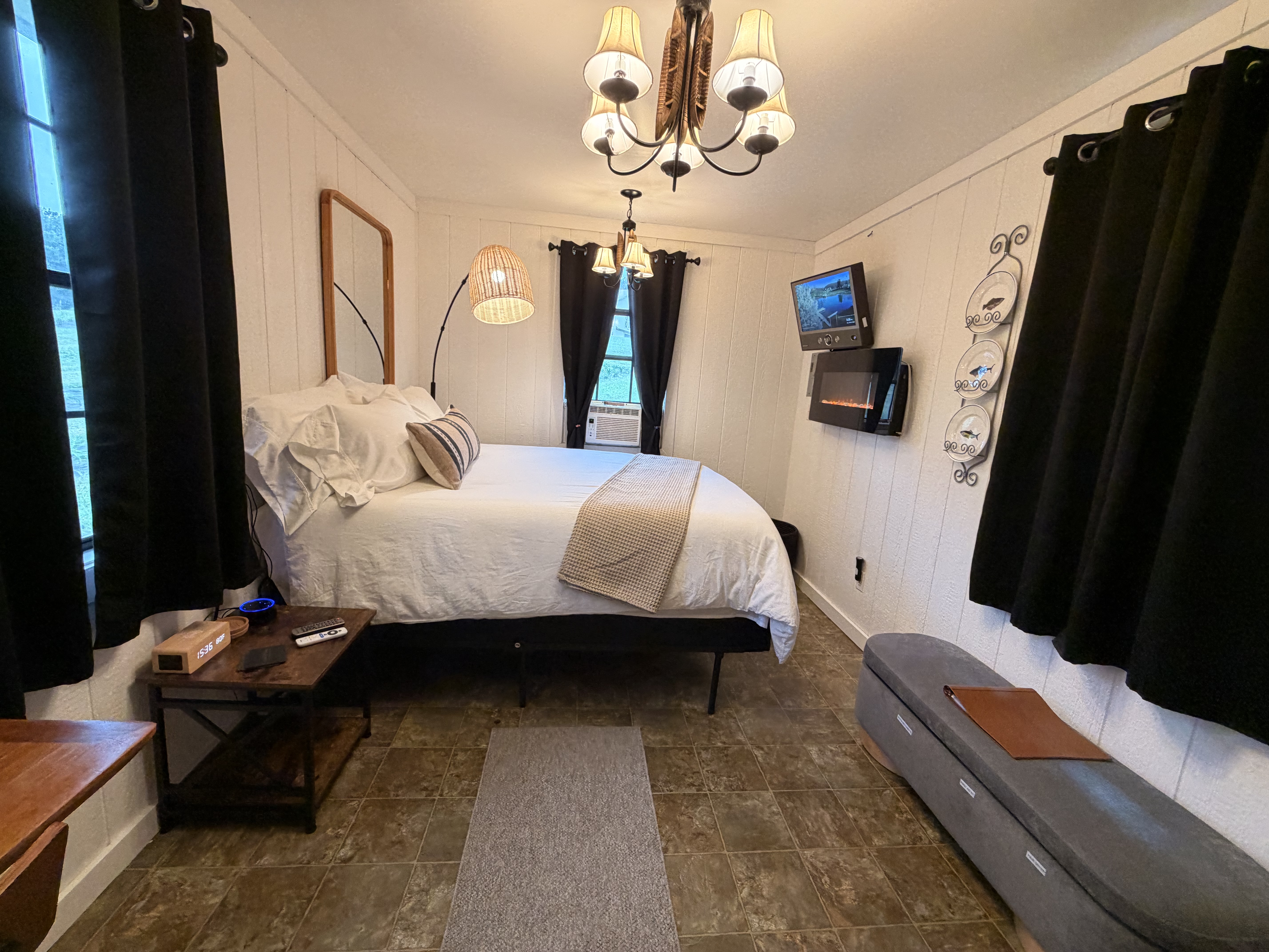Cozy bedroom with plush bedding, fireplace, and TV for a relaxing stay